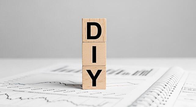 Wooden blocks spelling DIY on a financial report in a bright studio setting symbolizing creative problemsolving selfreliance and the empowering feeling of taking control of your own projects and finan photo