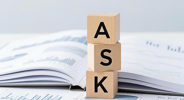 Wooden blocks spelling ASK stacked on financial reports in a bright office representing a concept of inquiry customer service and seeking information for business growth and problemsolving strategies photo