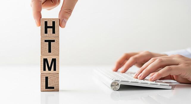 Developer arranging wooden blocks spelling HTML while typing on a keyboard in a bright minimalist office representing web development coding and the building blocks of website creation with a focus on photo