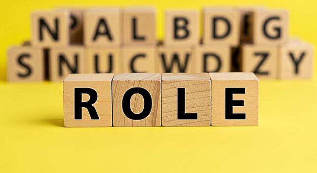 Wooden blocks spelling out ROLE on a bright yellow surface representing the concept of responsibilities and expectations in a playful and educational environment fostering learning and development photo