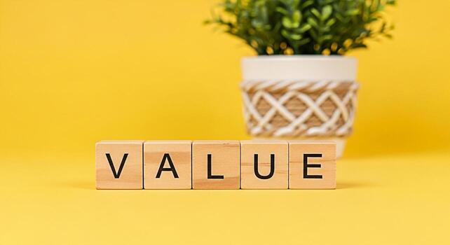 Wooden blocks spelling VALUE displayed on a bright yellow surface symbolizing core principles and importance with a potted plant in the background conveying a sense of growth stability and lasting wor photo