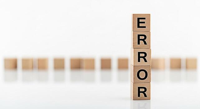 Tower of wooden blocks displaying the word ERROR in a minimalist white studio setting symbolizing system failure software bugs and the importance of quality assurance in technology and business operat photo