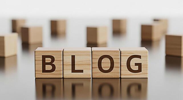 Wooden blocks spelling BLOG on a reflective surface surrounded by blurred blocks symbolizing online content creation and sharing in a digital age conveying a sense of information and connection photo