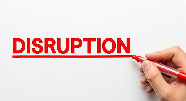 Hand underlining the word DISRUPTION in bold red letters on a clean white background symbolizing innovation change and the power of disruptive technologies in a modern business environment photo