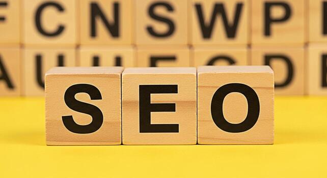 Wooden blocks spelling SEO on a vibrant yellow surface representing search engine optimization strategies and digital marketing success conveying a message of online visibility and effective website p photo