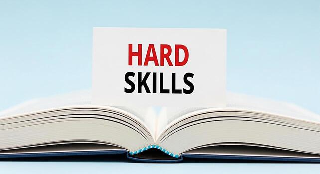 Open book displaying a card with the words HARD SKILLS in red and black text symbolizing the importance of acquiring specific knowledge and abilities for professional development and career advancemen photo