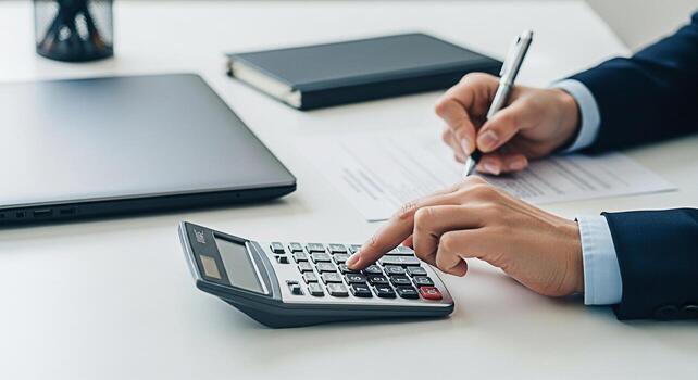 Focused accountant calculates figures and writes on a document in a bright office showcasing financial precision and attention to detail in a professional business environment emphasizing accuracy and photo