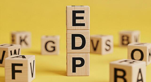 Wooden blocks spelling EDP stacked on a yellow surface surrounded by other lettered blocks representing economic development planning and strategic financial decisions with a bright and optimistic moo photo