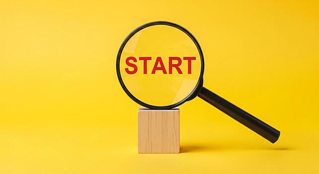 Magnifying glass focusing on the word START displayed on a vibrant yellow background symbolizing new beginnings business opportunities and the initial steps towards success and achievement photo