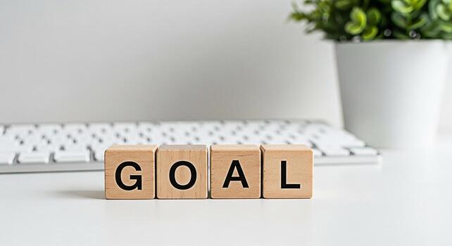 Wooden blocks spelling GOAL on a white desk symbolizing ambition and achievement in a minimalist office setting representing focus determination and the pursuit of success in business and personal dev photo