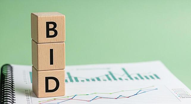 Wooden blocks spelling BID placed on a financial chart in a bright studio setting representing a business proposal and competitive offer conveying a sense of strategic planning and investment opportun photo