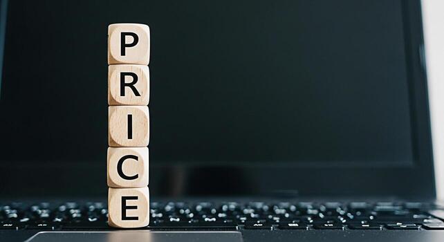 Wooden blocks spelling PRICE stacked on a laptop keyboard representing online shopping and ecommerce suggesting affordability and value in a digital marketplace with a focus on competitive pricing str photo