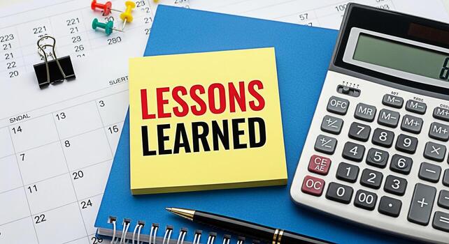 Analyzing lessons learned on a desk with calendar calculator pen and notepad reflecting on past experiences for future improvement and strategic planning in a professional office setting photo