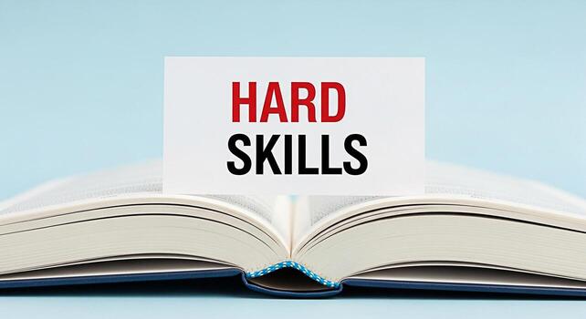 Open book displaying a card with the words Hard Skills in red and black on a light blue background symbolizing the importance of technical abilities and professional development for career success photo