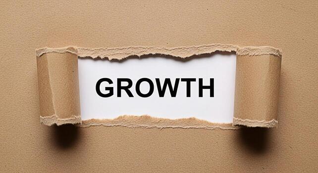 The word Growth revealed through torn brown paper symbolizing opportunity and potential in a business context representing progress development and positive change for a brighter future and success photo