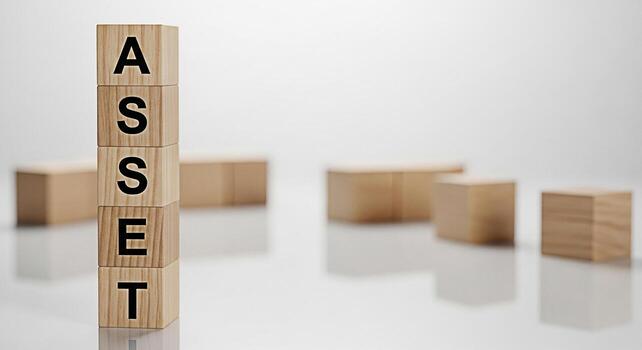 Wooden blocks spelling ASSET stacked high on a reflective surface in a minimalist studio setting representing financial security investment growth and the importance of managing resources effectively photo