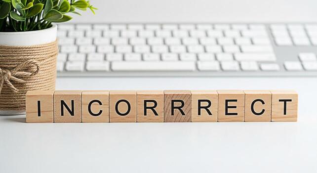 Wooden blocks spelling INCORRECT on a white desk in a bright office setting symbolizing error detection and the importance of accuracy in business and education with a focus on quality control photo