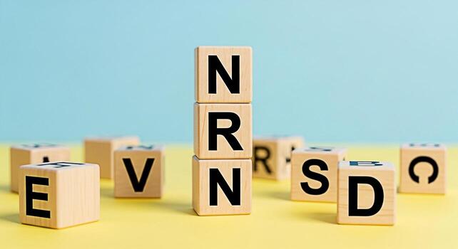 de madera alfabeto bloques ortografía fuera nrn apilado alto en un amarillo superficie en contra un azul antecedentes creando un juguetón y educativo atmósfera para aprendizaje y desarrollo ideal para para niños conten foto