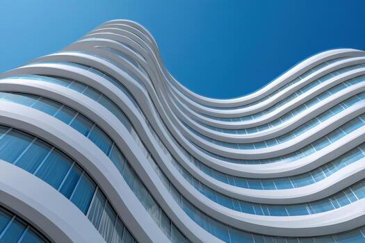 Modern building with curved architecture under clear blue sky photo