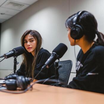 Engaging podcast discussion between two hosts in a modern studio setting photo