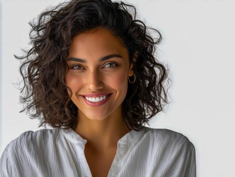 Diverse team member smiles in a comfortable white shirt against a plain background photo