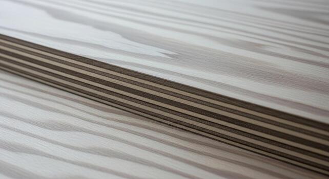 Close-up shot of light-colored wood grain texture with contrasting layered edge, creating a striking visual pattern, perfect for backgrounds and design elements photo