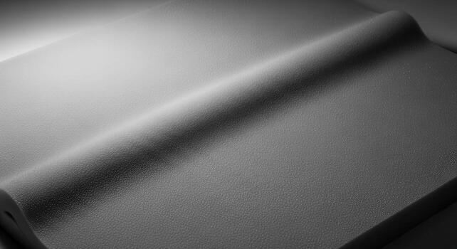 Close-up studio shot of a gray closed-cell foam sheet with uniform bead texture, soft compressions, and subtle gradient effects illuminated by soft light, devoid of text or lettering photo