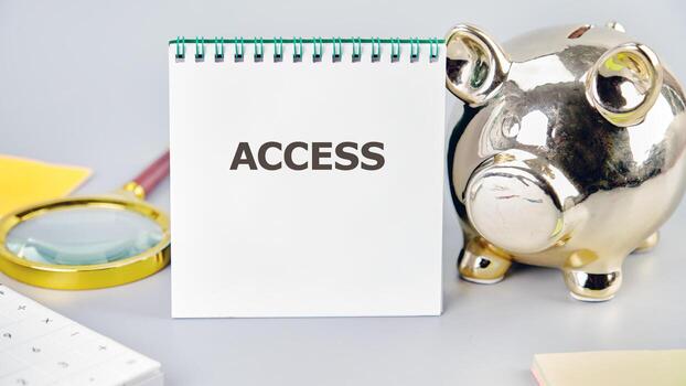 ACCESS word written in a notebook in a composition with a piggy bank and a magnifying glass. Cybersecurity security and encryption concept photo