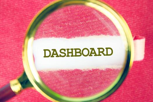 DASHBOARD word was found using a magnifying glass under a piece of paper. Data Analysis for Business and Finance Concept. photo