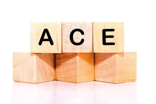 Stacked wooden blocks display the letters A, C, and E, showcasing a simple yet eye-catching arrangement on a clean white background photo