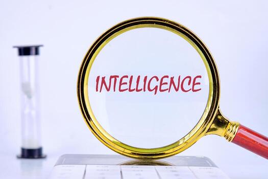 INTELLIGENCE text was revealed through a magnifying glass on a light background that was on the calculator. Futuristic Concept of Intelligence, science and mind photo