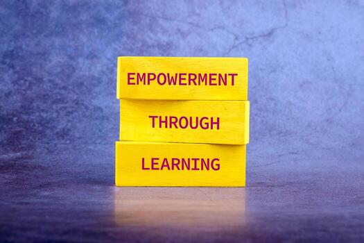 The message connect through learning. EMPOWERMENT THROUGH LEARNING on wooden blocks on a bright background photo
