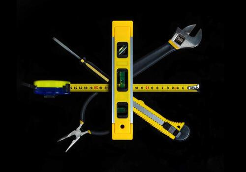 Set tools for master builder on a black background. Idea for building or renovation. Top view photo
