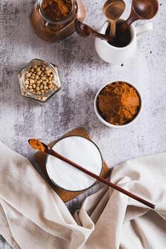 Miso-Spiked latte in a glass and a bowl of miso paste on the table top and vertical view photo
