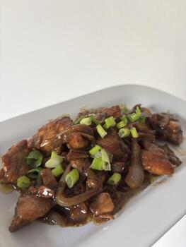 Ayam kecap, chicken with soysauce on white plating upper side view photo