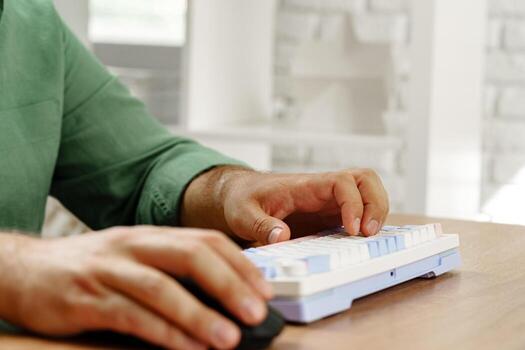 Hands typing on a computer keyboard while using a mouse in a modern workspace photo
