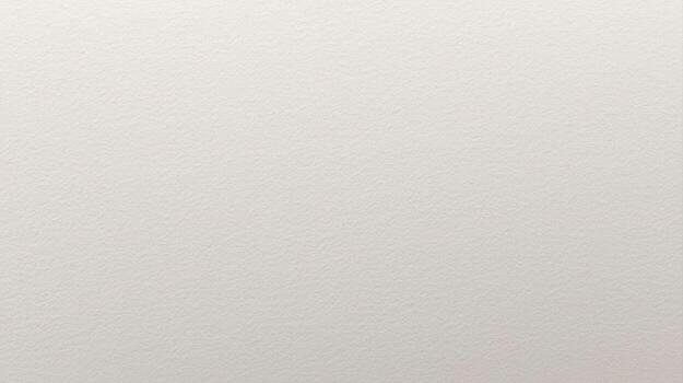 A detailed close up of a smooth, textured light cream colored paper surface reveals subtle variations in tone and a slightly granular feel. photo