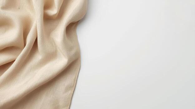 A soft beige linen fabric gently drapes along the left edge creating a warm inviting textured background with a spacious white blank area. photo