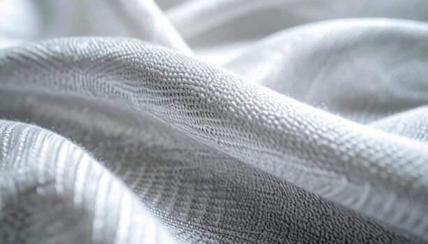 The soft shimme light delicately illuminates the graceful folds and intricate woven texture of a luxurious silver fabric background image. photo