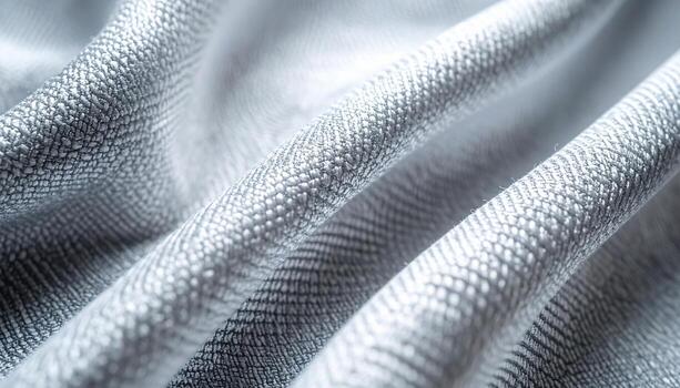 el suavemente cubierto plata tela reluce con un sutil textura, creando delicado pliegues y amable Destacar debajo difundido estudio Encendiendo. foto