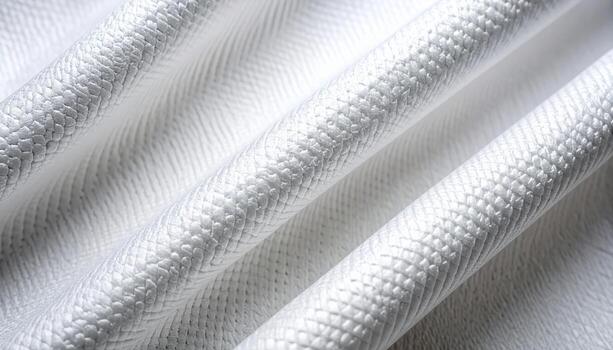 Detailed close up of white woven fabric texture shows repeating pattern and subtle folds creating soft light and shadow effects beautifully. photo