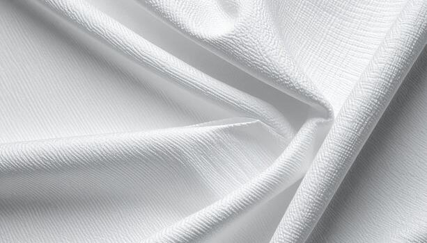 The pristine white fabric exhibits a delicate texture with soft, flowing folds that create a visually appealing and tactile impression. photo