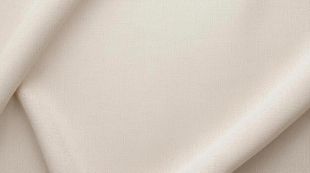 The soft, creamy beige fabric is draped gently, creating subtle folds and a textured surface, perfect for backgrounds and design projects. photo