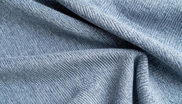 un de cerca de suave, texturizado azul tela con visible lineal patrones y sutil pliegues crea un visualmente atractivo, táctil superficie diseño. foto