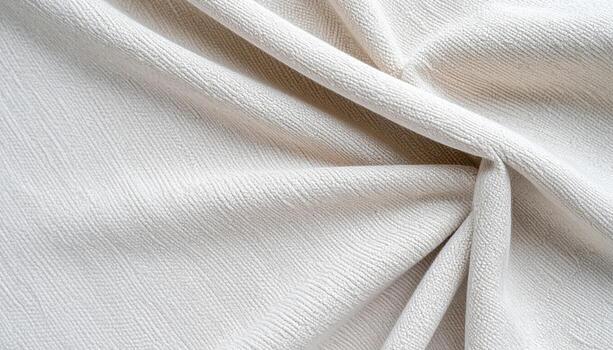 Soft ivory fabric delicately draped with subtle folds showcasing the material's texture and creating a gentle, elegant, and smooth surface. photo