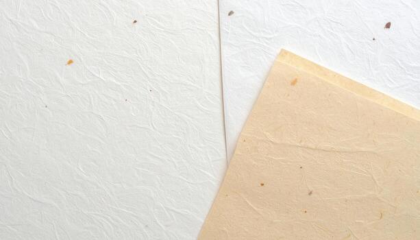 Handmade textured paper in shades of cream and white provide a natural and delicate background for graphic design and artistic projects. photo