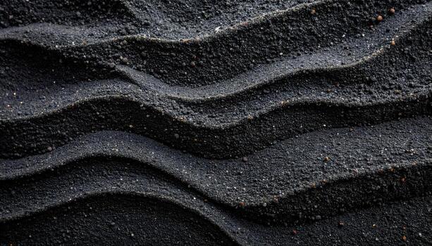Abstract close up of dark volcanic sand with curved ridges creating a mesmerizing pattern of shadows and textures across the entire image. photo