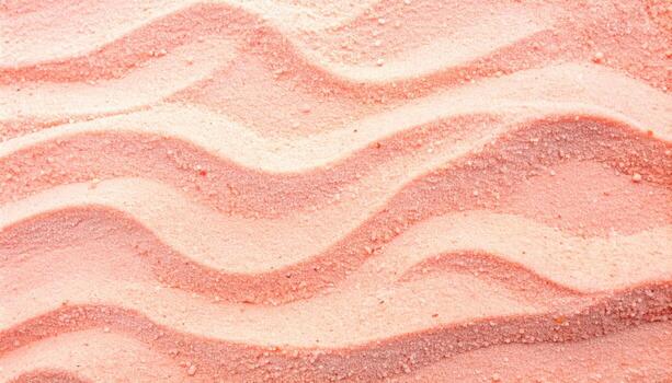 Top view of rippled pink sand creating a calming and textured beach background reminiscent of summer vacations and tropical destinations. photo