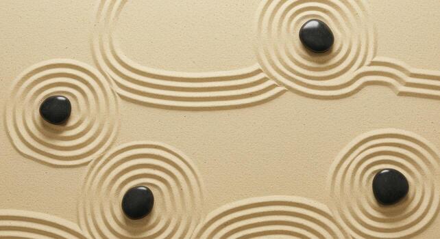 Close up on zen garden with circular sand pattern and smooth stones arranged to promote serenity and calmness in a spa setting experience. photo