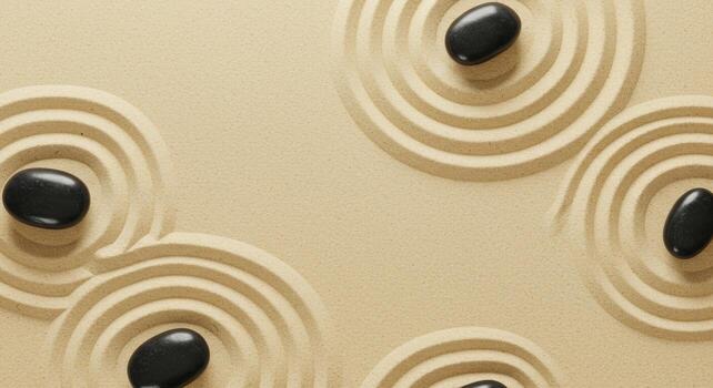 Minimalist zen garden with smooth black stones arranged on the raked sand surface creating peaceful concentric circles for meditation session. photo